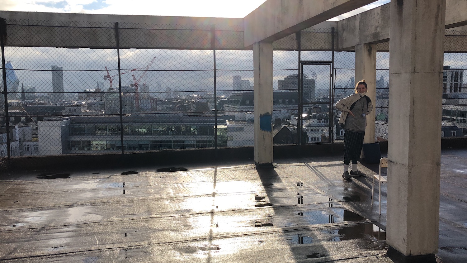 agnes standing on a roof overlooking the city of london