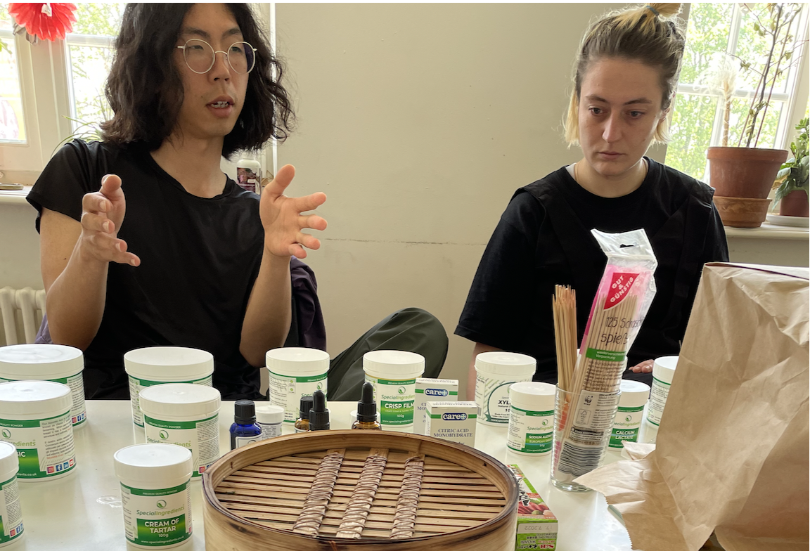 agnes and gary looking at tubs of ingredients